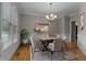 Elegant dining room featuring modern decor, wood floors, and natural light with a chandelier at 3642 Fowler Rdg, Douglasville, GA 30135