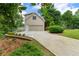 Exterior showcasing a house with attached garage, driveway, and manicured landscaping at 3642 Fowler Rdg, Douglasville, GA 30135