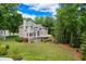 A beautiful two-story home with a landscaped yard and deck is surrounded by lush greenery at 3642 Fowler Rdg, Douglasville, GA 30135