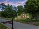 Beautiful traditional home surrounded by mature trees and pristine landscaping near Fowler Ridge sign at 3642 Fowler Rdg, Douglasville, GA 30135