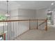Spacious foyer with wood railing overlooking the front door at 3642 Fowler Rdg, Douglasville, GA 30135