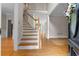 Inviting foyer showcases hardwood floors, a staircase, and a view into the living area. Plus a beautiful front door at 3642 Fowler Rdg, Douglasville, GA 30135