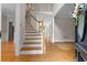 Light-filled foyer features hardwood floors, staircase, and a view into other rooms at 3642 Fowler Rdg, Douglasville, GA 30135