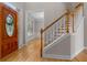 Warm foyer with wood floors, a staircase, and a stained glass front door lets in lots of natural light at 3642 Fowler Rdg, Douglasville, GA 30135