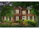 Beautiful brick two-story home with black shutters and lush green landscaping at 3642 Fowler Rdg, Douglasville, GA 30135