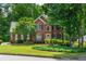 Charming two-story brick home featuring black shutters, manicured landscaping, and a lush green lawn at 3642 Fowler Rdg, Douglasville, GA 30135