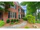 Elegant brick home with black shutters, a paved walkway, and meticulously maintained landscaping at 3642 Fowler Rdg, Douglasville, GA 30135