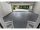 Open garage featuring freshly painted floors and access to driveway at 3642 Fowler Rdg, Douglasville, GA 30135