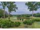 Scenic view of a golf course with a tranquil pond and lush greenery, offering a picturesque recreational setting at 3642 Fowler Rdg, Douglasville, GA 30135