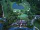 Aerial view of a pristine golf course community featuring mature trees and a gorgeous pond at 3642 Fowler Rdg, Douglasville, GA 30135