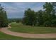 Scenic view of a winding golf cart path along a lush green golf course with mature trees lining the fairway at 3642 Fowler Rdg, Douglasville, GA 30135