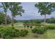 Scenic golf course view features lush greens, a tranquil pond, and mature trees on a cloudy day at 3642 Fowler Rdg, Douglasville, GA 30135