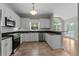 Bright kitchen features white cabinetry, stainless appliances, tile backsplash, granite counters, and adjoining breakfast nook at 3642 Fowler Rdg, Douglasville, GA 30135
