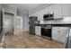 Updated kitchen with white cabinets, stainless steel appliances, and tile flooring, plus a stylish granite countertop at 3642 Fowler Rdg, Douglasville, GA 30135