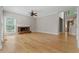 Large living area features hardwood floors, a brick fireplace, and big windows letting in lots of natural light at 3642 Fowler Rdg, Douglasville, GA 30135