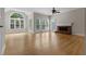 Spacious, light-filled living room with hardwood floors and a charming brick fireplace at 3642 Fowler Rdg, Douglasville, GA 30135