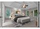 Beautifully staged main bedroom with a modern bed, ample natural light, and elegant decor at 3642 Fowler Rdg, Douglasville, GA 30135