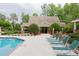 A view of the community pool house featuring a brick trim and nearby lounge chairs at 3642 Fowler Rdg, Douglasville, GA 30135