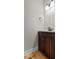 Powder room with wood floors, dark wood vanity, and neutral wall color at 3642 Fowler Rdg, Douglasville, GA 30135