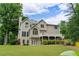 Rear view of home with large deck, walk out basement and lush green lawn at 3642 Fowler Rdg, Douglasville, GA 30135