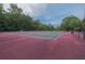 A view of tennis courts, surrounded by trees at 3642 Fowler Rdg, Douglasville, GA 30135