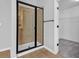 Modern bathroom with glass-enclosed shower, dark hardware and earth-toned tile work at 4238 Sir Dixon Dr, Fairburn, GA 30213