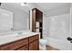 Bathroom featuring a single sink vanity with wood cabinets and a shower and tub combination at 4238 Sir Dixon Dr, Fairburn, GA 30213