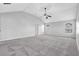 A spacious bedroom featuring neutral carpeting, two windows and a ceiling fan at 4238 Sir Dixon Dr, Fairburn, GA 30213