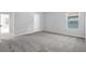 Neutral bedroom with door to bath and walk-in closet, light gray carpet, and natural light at 4238 Sir Dixon Dr, Fairburn, GA 30213