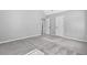 A bedroom with plush carpeting and two white doors at 4238 Sir Dixon Dr, Fairburn, GA 30213
