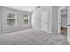 Bedroom featuring vaulted ceiling, two windows, and doorway to bath, offering ample natural light at 4238 Sir Dixon Dr, Fairburn, GA 30213