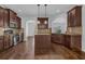 Well-equipped kitchen with dark wood cabinets, stainless appliances, granite counters, and a central island at 4238 Sir Dixon Dr, Fairburn, GA 30213