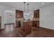 Bright kitchen featuring wooden cabinets, countertops, a kitchen island and modern pendant lighting at 4238 Sir Dixon Dr, Fairburn, GA 30213