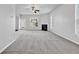 Open living area with fireplace and large windows offering plenty of natural light at 4238 Sir Dixon Dr, Fairburn, GA 30213