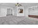 An open-concept living room with neutral carpet, arched doorways, and views into other rooms at 4238 Sir Dixon Dr, Fairburn, GA 30213