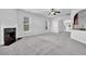 Spacious living room boasting a fireplace, neutral carpeting and ample natural light at 4238 Sir Dixon Dr, Fairburn, GA 30213