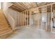 Unfinished basement with exposed beams and a staircase to the upper floors at 431 Hinton Farm Way, Dacula, GA 30019