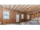 Unfinished basement with exposed framing, windows, and a door to the outside at 431 Hinton Farm Way, Dacula, GA 30019