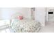 Inviting bedroom with floral bedding and an ensuite bathroom and easy access to another room at 431 Hinton Farm Way, Dacula, GA 30019