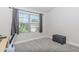 This bedroom has a window providing natural light and carpeted floor at 431 Hinton Farm Way, Dacula, GA 30019