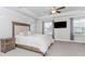 Spacious bedroom featuring tray ceilings, a ceiling fan, and a mounted television for added convenience at 431 Hinton Farm Way, Dacula, GA 30019