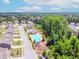 Aerial view of community with neighborhood pool and playground surrounded by mature trees at 431 Hinton Farm Way, Dacula, GA 30019