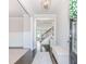 Bright entryway features a decorative light fixture, white trim, wainscoting and dark wood floors at 431 Hinton Farm Way, Dacula, GA 30019