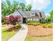 Charming brick building with a welcoming entrance, beautiful landscaping, and well-maintained lawn at 431 Hinton Farm Way, Dacula, GA 30019