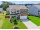 Beautiful two-story home with stone accents, a well-manicured lawn, and a two-car garage at 431 Hinton Farm Way, Dacula, GA 30019