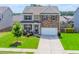 Charming two-story home featuring a stone facade, well-manicured lawn, and a welcoming front porch at 431 Hinton Farm Way, Dacula, GA 30019
