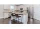 Modern kitchen with stainless steel appliances, granite countertops, and an island with bar seating at 431 Hinton Farm Way, Dacula, GA 30019