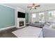 Cozy living room featuring a fireplace, hardwood floors, and plenty of natural light at 431 Hinton Farm Way, Dacula, GA 30019
