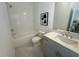 Clean bathroom featuring a tub with tile surround, a modern vanity, and tile flooring at 502 Healy Dr # 76, Cumming, GA 30040