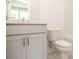 Cozy bathroom featuring a vanity with modern fixtures, a commode, and tiled walls at 502 Healy Dr # 76, Cumming, GA 30040